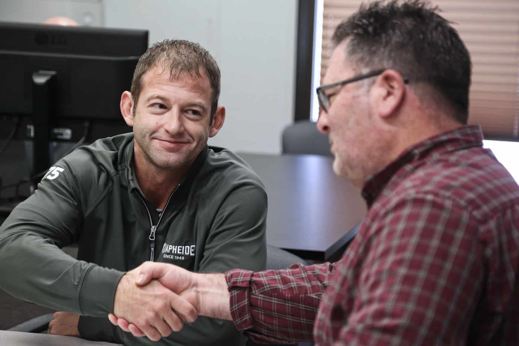 knapheide sales rep and customer shaking hands