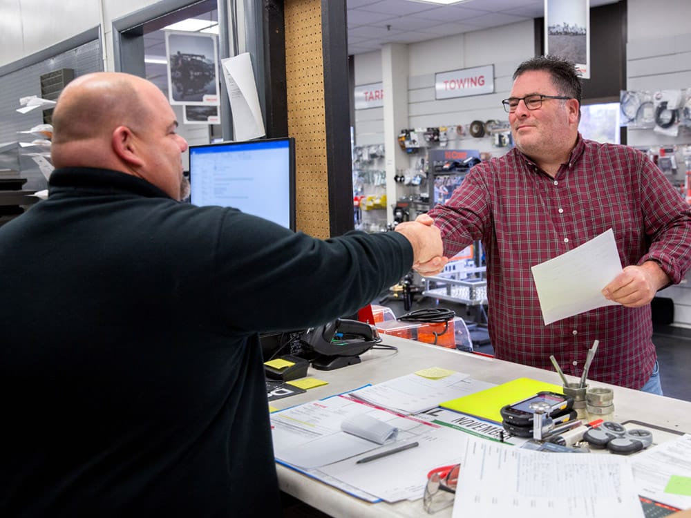 ktec parts counter customer and rep shaking hands