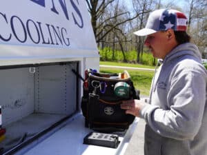 Mommens Heating And Cooling Field Tech Grabbing Toolbag From Kuv Van Compartment