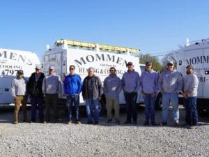 Mommens Heating And Cooling Field Techs Standing Near Kuv Van Fleet