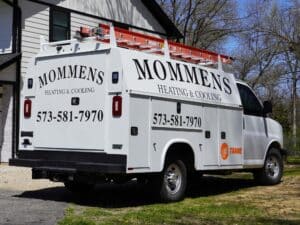 Mommens Heating And Cooling Kuv Van On Jobsite Curbside View