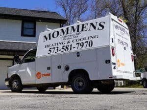 Mommens Heating And Cooling Kuv Van On Jobsite Streetside View