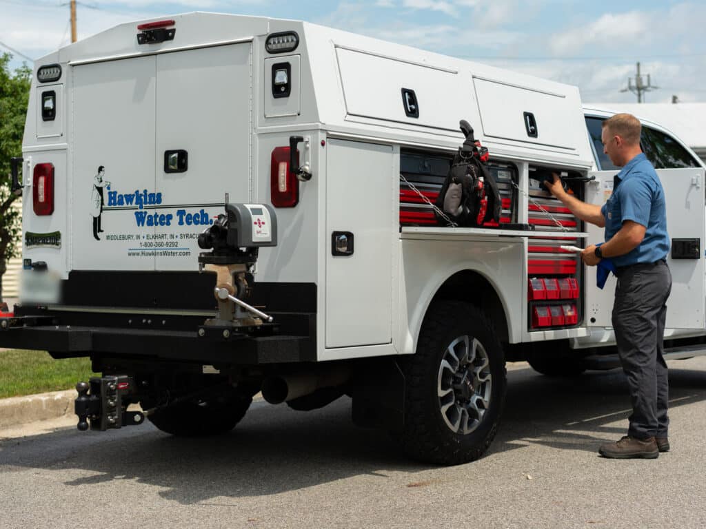 Hawkins Water Tech Enclosed Service Truck Field Technician Accessing Side Compartments