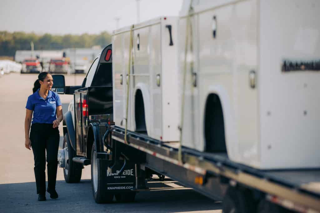 Knapheide Employee Alongside Truck And Trailer Loaded With Knapheide Service Bodies