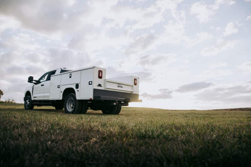 Knapheide Service Truck Parked On Grass Lot With Sunset