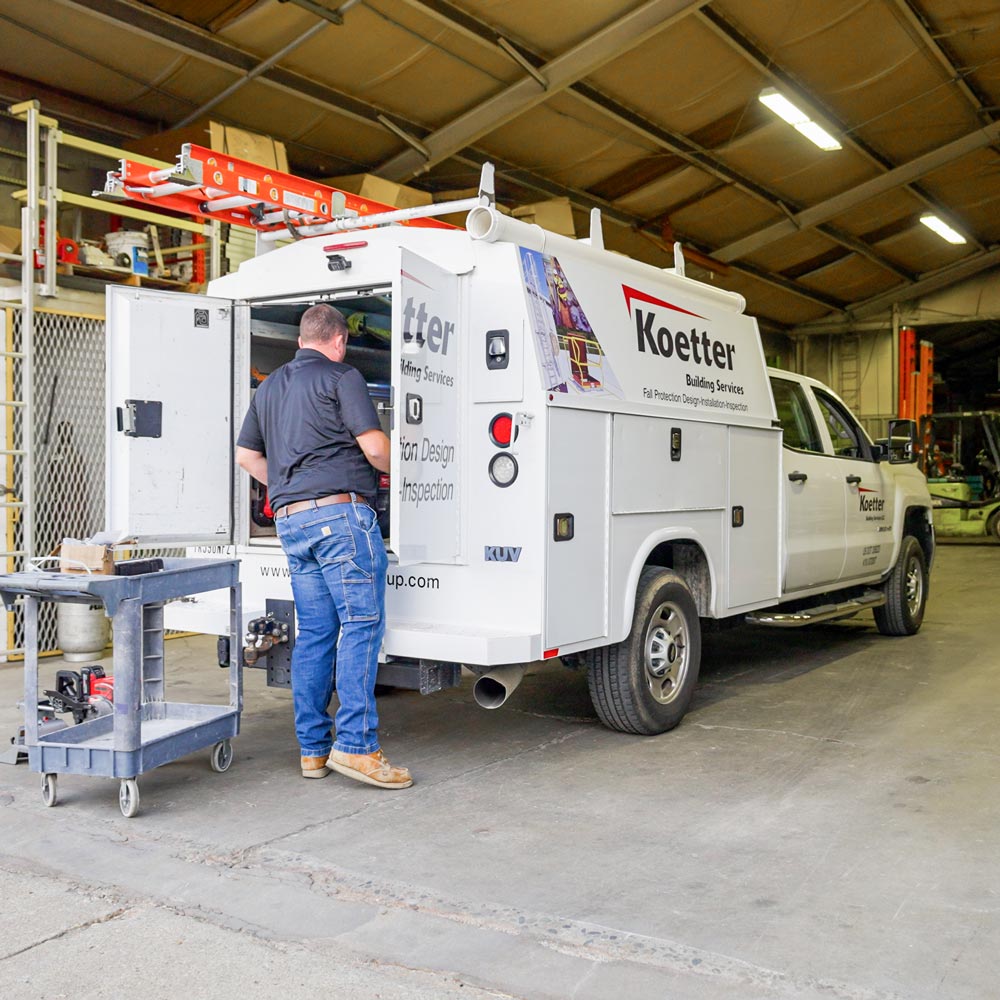 the-koetter-group-worker-loading-knapheide-kuvcc-enclosed-service-truck-in-warehouse