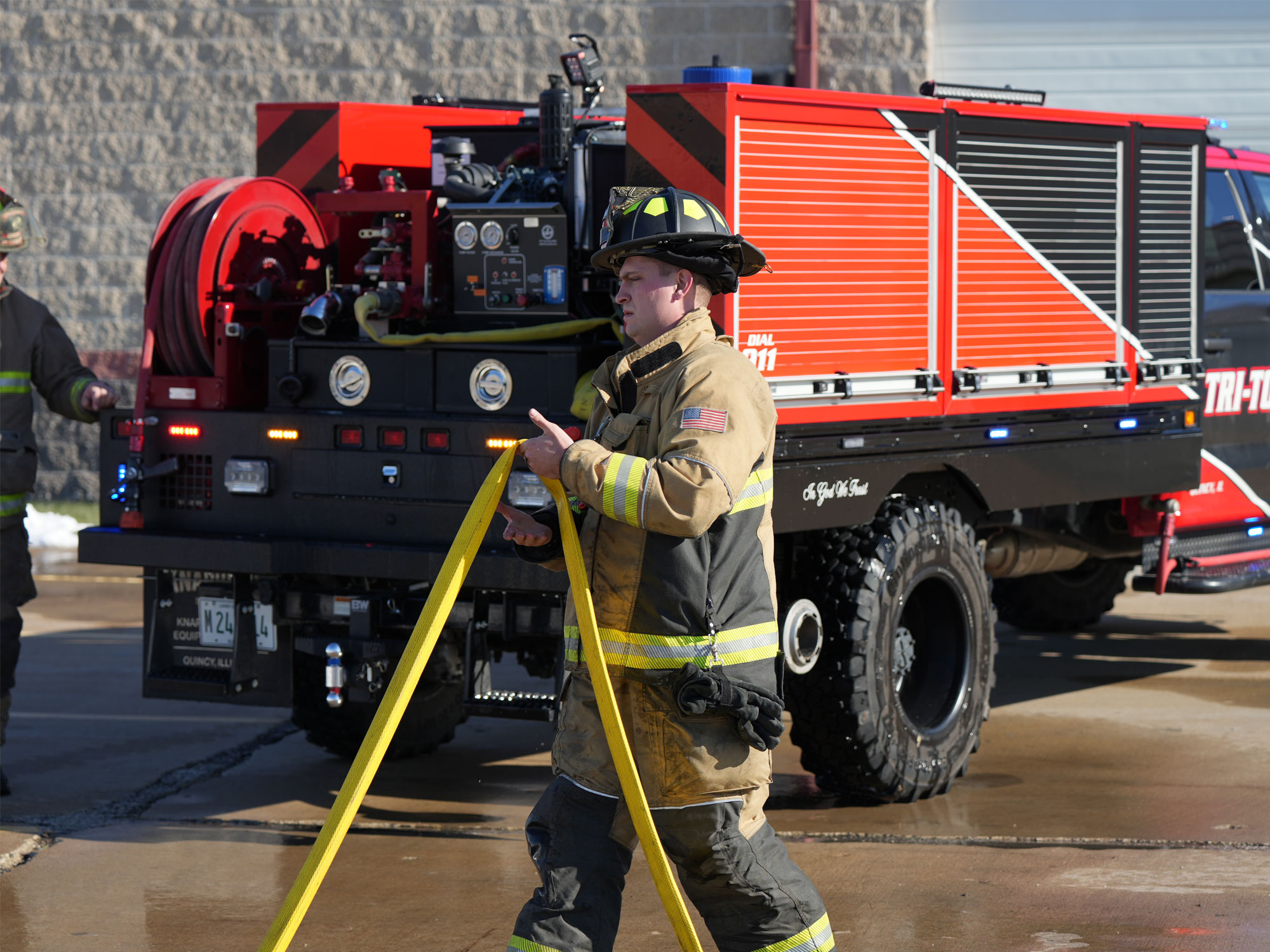 Tri Township Fire Department Firefighter Handling Water Hose Near Knapheide Brush Truck