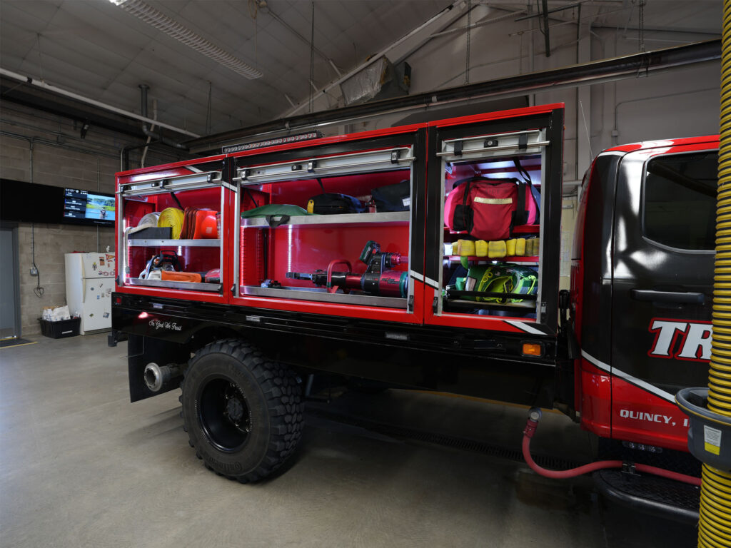 Tri-Township-Fire-Department-Knapheide-Brush-Truck-Open-Curbside-Roll-Up-Door-Compartments-While-Parked-In-Garage