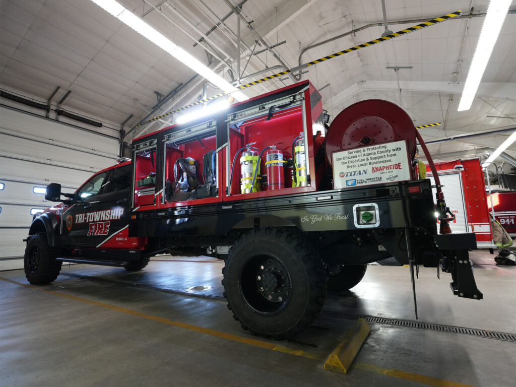 Tri-Township-Fire-Department-Knapheide-Brush-Truck-Open-Streetside-Roll-Up-Door-Compartments-While-Parked-In-Garage