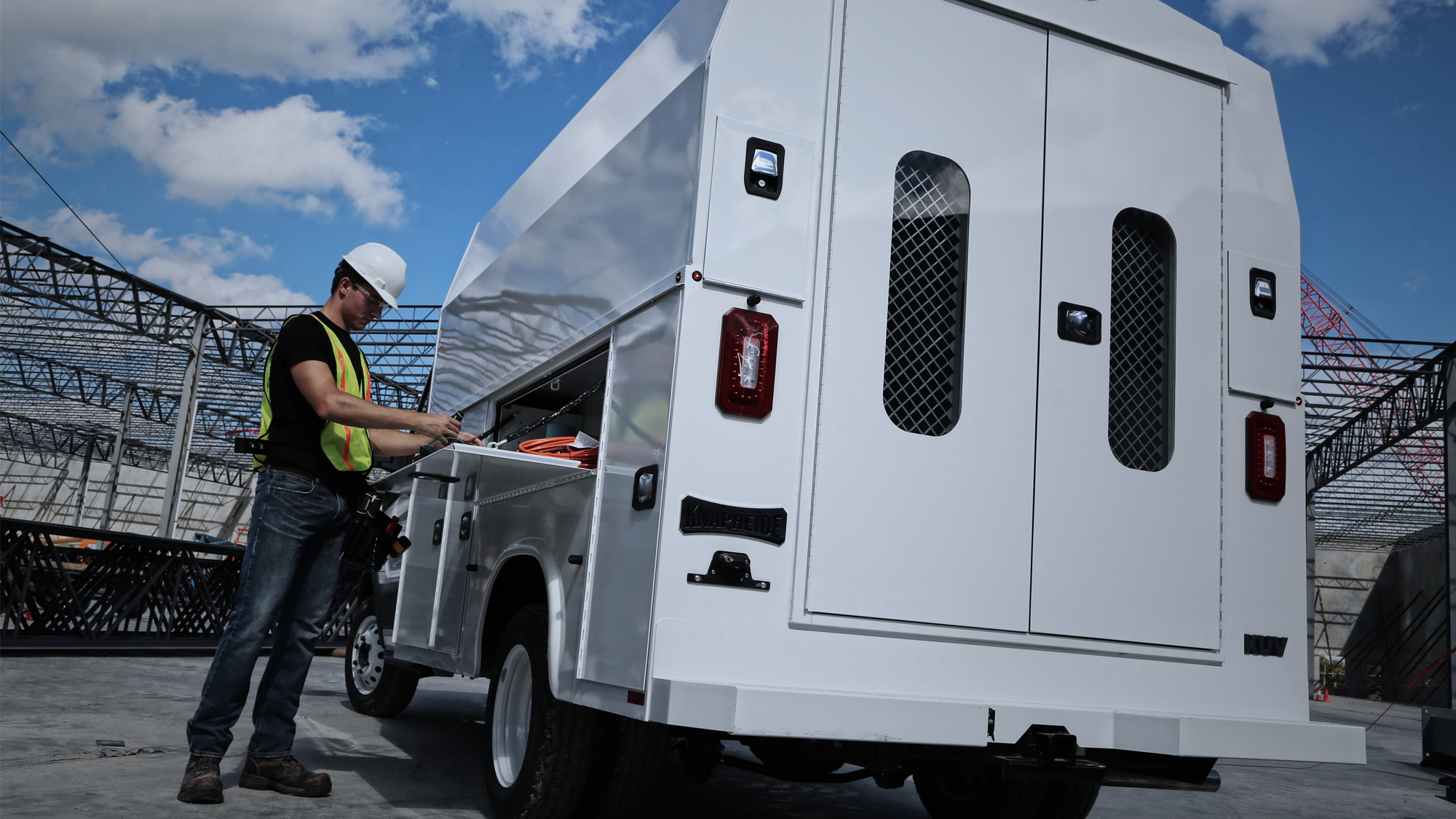 Contractor-Accessing-Wheel-Welll-Compartment-of-Windowed-Knapheide-KUV-Van