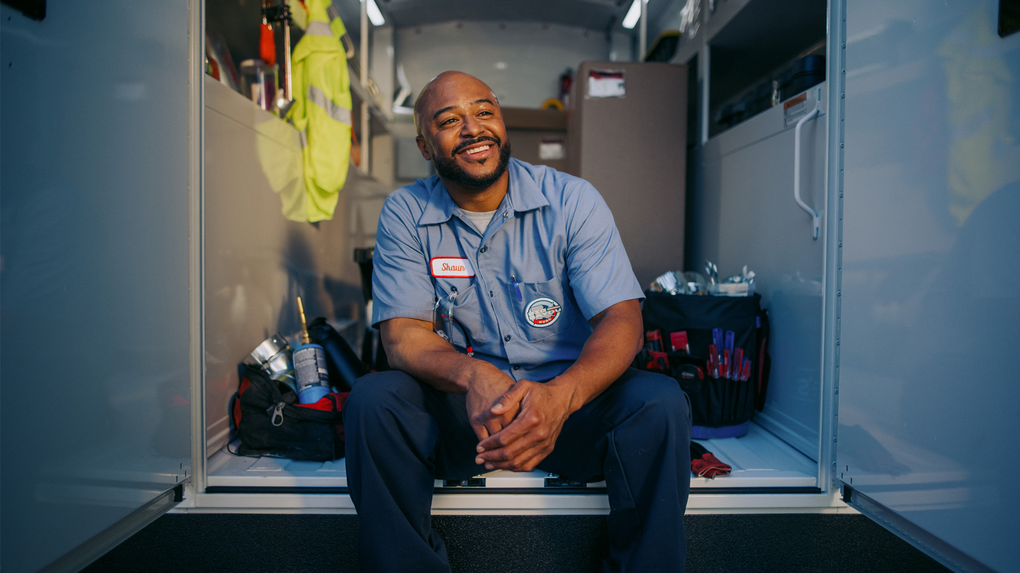 HVAC-Technician-Sitting-In-Cargo-Area-of-Knapheide-KUV-Van