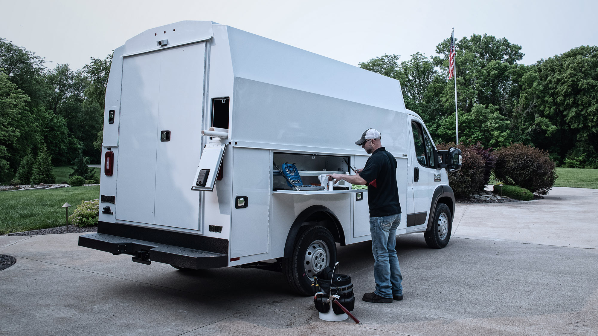 Plumber-Grabbing-Cargo-from-Knapheide-KUV-Van