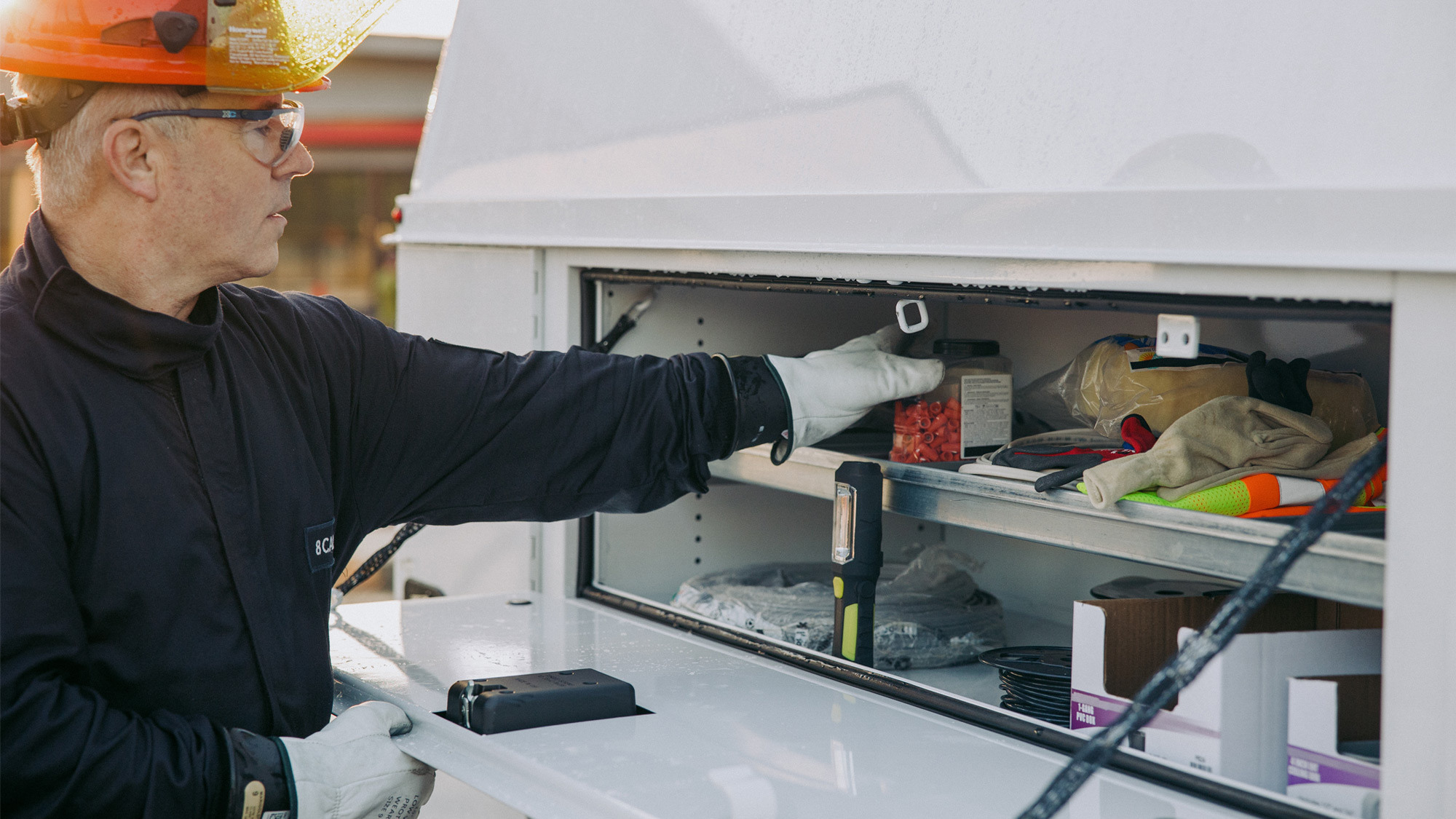 Service-Professional-Grabbing-Supplies-from-Wheel-Well-Compartment-of-Knapheide-KUV