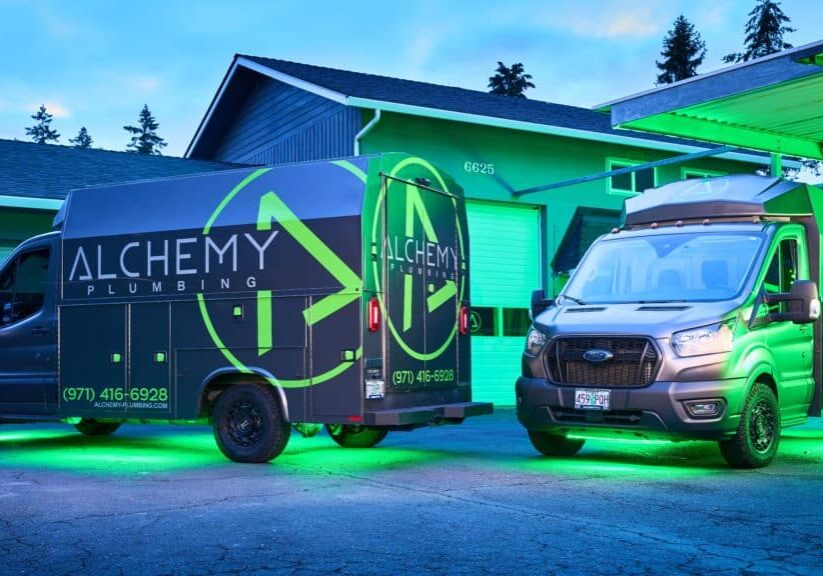 Two Knapheide KUVs with green underbody lighting in the twilight